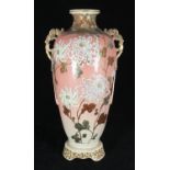 A late 19th /early 20th century Japanese pottery vase with stylised dragon handles and enamel floral