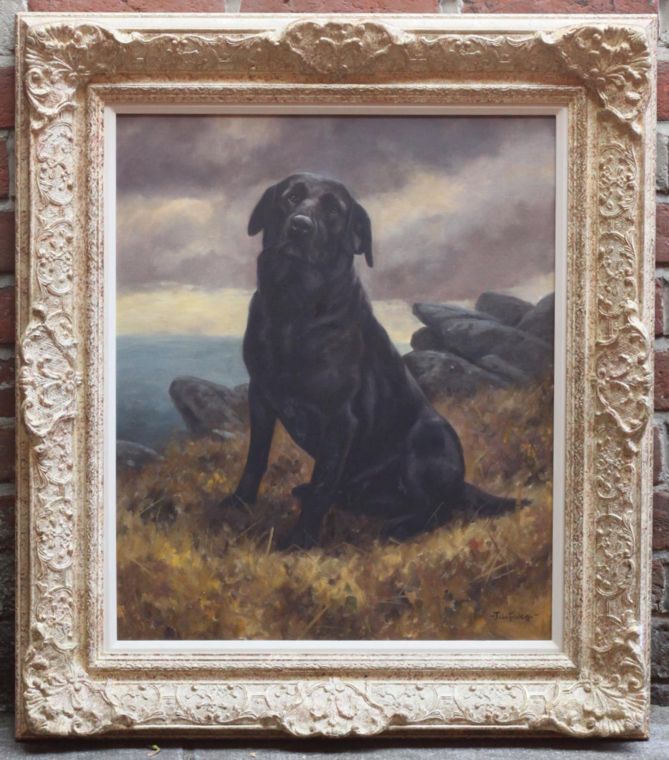 John Trickett (b.1952) Portrait study of a seated black Labrador on a hilltop, with sea and