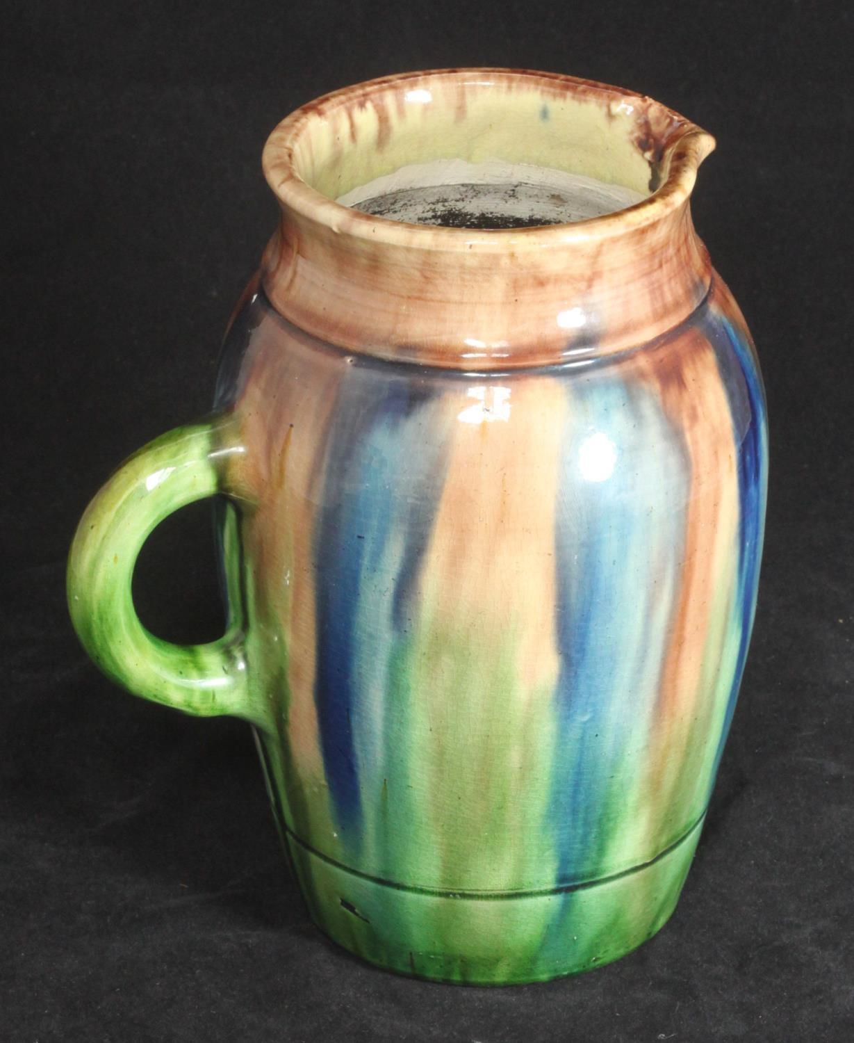 A 20th century 'Whieldon' style pottery jug, finished in a blue, brown and green glaze, impressed