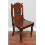 A late Victorian oak hall chair with Japanese lacquered panel.