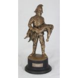 A bronzed statue of a Firefighter in 19th century uniform carrying a girl entitled 'Saved', raised