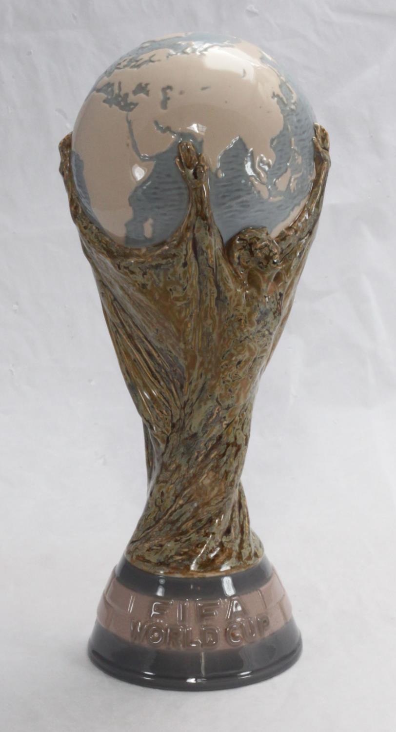 A rare Lladro porcelain copy of the FIFA World Cup, together with a photograph of England?s most