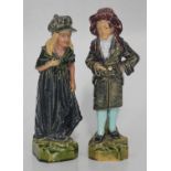 A pair of 19th century continental glazed pottery figures of a girl and boy, decorated in polychrome