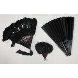 Three assorted fans, one with simulated tortoiseshell sticks and black feathers (possibly ostrich)