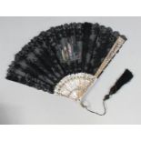 A good quality lace fan, the pink mother of pearl sticks with pierced and gilded floral