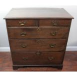 An early 18th century stained oak chest of two short and three long graduated drawers, later brass