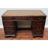 A stained walnut twin pedestal desk with inset gilt-tooled brown leather scribe, 122cm wide