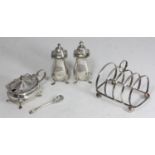 A three-piece silver condiment set comprising salt, pepper and mustard with blue glass liner and