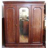 A 19th century mahogany triple linen press/wardrobe, enclosed handing space, laundry compartment,