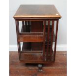 A 1920s stained oak revolving bookcase of square section, 50cm square