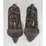 A pair of antique carved and painted wooden wall-hanging figures of female Hindu dancers, North