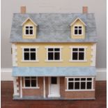 ROWANS APPEAL - A large dolls house with front porch and dormer windows to lift-up roof together