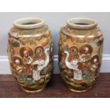 A pair of Japanese satsuma pottery vases, moulded in relief, with deities and painted in