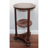 A 19th century Biedermeier style circular two tier occasional table with Doric column supports,