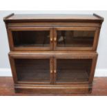 A two-section stained oak low bookcase, with hinged and glazed doors, 89cm wide