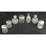 Seven various silver-mounted cut glass toilette jars and bottles, (three pairs and a single)
