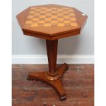 A Victorian mahogany octagonal occasional table with rosewood and satinwood chessboard top, tapering