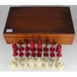 A carved and stained bone chess set, complete, with stained walnut box