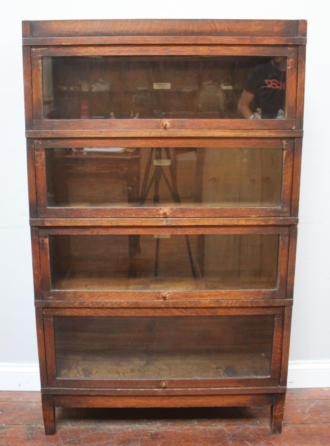 A Globe-Wernicke four-section stained oak glazed bookcase, 88cm wide