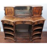 A high Victorian burr-walnut writing desk, with concave doors and mirrored recess to the