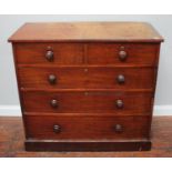 A Victorian stained walnut chest of two short and three long graduated drawers, with turned pulls,