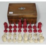 A carved and stained bone chess set, complete, with stained walnut domed box with MOP inlay