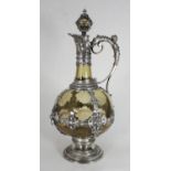 A Renaissance style hock wine ewer with tinted bulbous glass body mounted with white metal