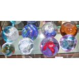 Eight assorted glass paperweights comprising seven Caithness examples