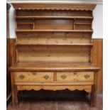 An 18th century and later stripped and waxed pine kitchen dresser, 177x210cm