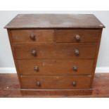 A Victorian stained oak chest of two short and three long graduated drawers with turned pulls, on
