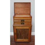 An early 20th C, faded walnut collectors cabinet, with hinged top above a pair of shallow drawers