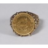 A 1981 1/10oz Krugerrand, set in a 9ct gold ring with pierced and foliate decoration, gross weight