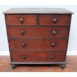 A Victorian stained walnut chest of two short and three long graduated drawers, with original turned