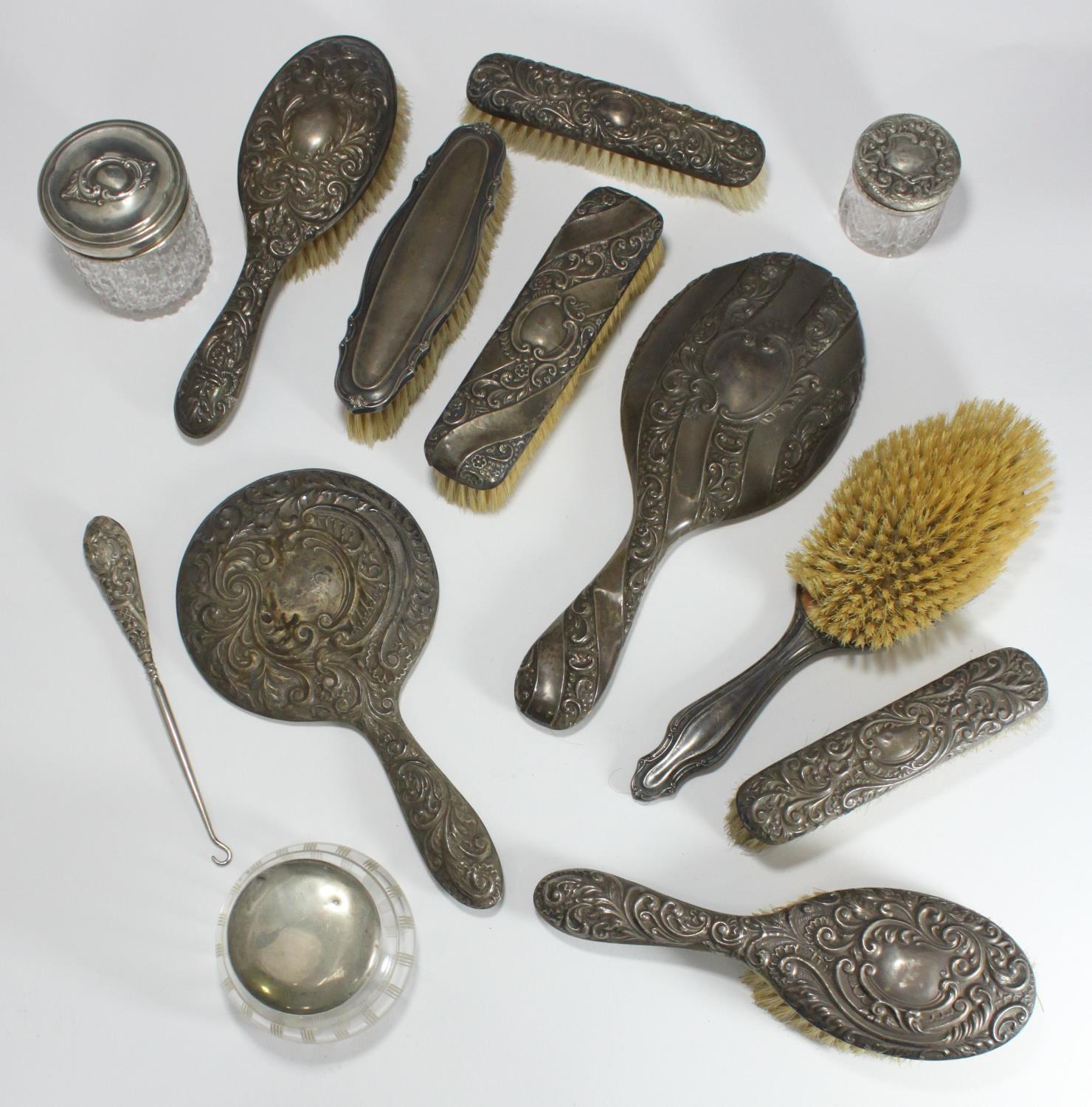 Nine various silver-backed brushes and mirrors, together with a silver-handled glove hook