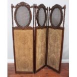 A stained walnut three-fold dressing screen, with oval rattan panels, barley-twist uprights and