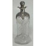 An Edwardian silver mounted glass decanter of cruciform shape, with four spouts and silver