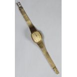 A ladies 9ct gold Longines wristwatch, the gilt dial with Roman numerals denoting hours, on integral