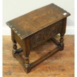 An antique and later small oak chest, the hinged top enclosing storage space, possibly a candle box,