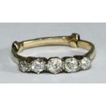 A yellow metal (tests as 18ct gold) ring, the top set with five old cut diamonds, estimated total