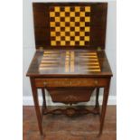 An Edwardian rosewood and marquetry ladies work and games table, the hinged top opening to reveal