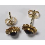 A pair of 15ct gold filigree stud earrings set with cabochon garnets, circa 1870, total weight 2.0g