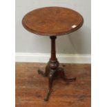 A 19th century stained walnut circular tripod table, on tunred column and carved tripod base,