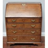 A George III oak bureau, with sloped-front enclosing pigeonholes and drawers, the whole with four