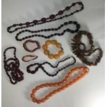 An amber bracelet together with two amber coloured bracelets and six amber coloured necklaces (9)