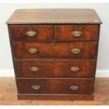 A George III mahogany chest of two short and three long graduated drawers, with replacement oval