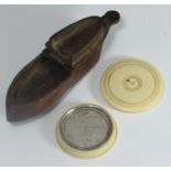 A treen snuff box in the shape of a ladies shoe, together with a Dutch silver token engraved in