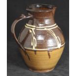 A circa 1938 Michael Cardew slipware pottery jug decorated in brown running glazes with abstract