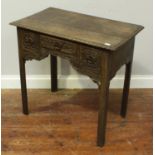 A 19th Century stained oak sidetable of rectangular form with carved edge, and three carved drawers,