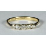 An 18ct gold ring set with five small graduating diamonds, gross weight approx. 2.2g