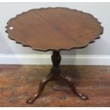 A 19th century stained mahogany tripod table, with piecrust top, baluster column and three down-